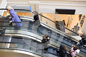 Peoples on escalators in a mall