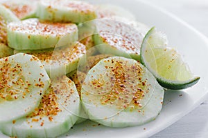 Pepinos con chile, Slices of cucumbers and chili, mexican snack, spicy food in mexico photo
