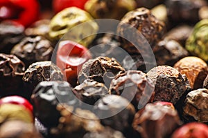 Pepper corns on a wooden board