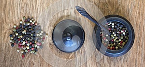 Pepper corns in a wooden pot.