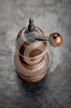 Pepper grinder on dark background