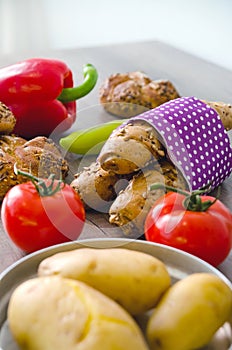 Pepper, potato, kaiser bun and baguette on wood table. Vegetarian bio food concept.