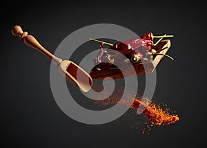 Pepper powder is poured out of the wooden spoon