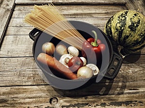pepper pumpkin pepper tomatoes champignons spaghetti wood background food ingredient close-up pan