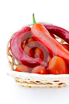 Pepper red tomato set vegetable basket beige closeup on white background
