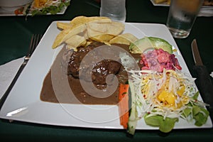 Pepper steak under a peppercorn sauce with fries and vegetable salad