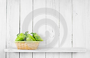 Pepper on a wooden shelf.