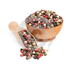 Peppercorn mix in a wooden bowl isolated on white