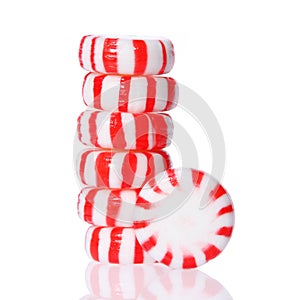 Peppermint candy tower on white. Red striped peppermint Christmas candy