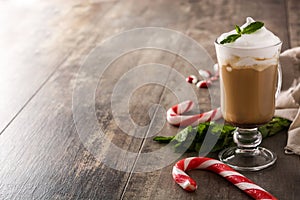 Peppermint coffee mocha for Christmas on wood photo