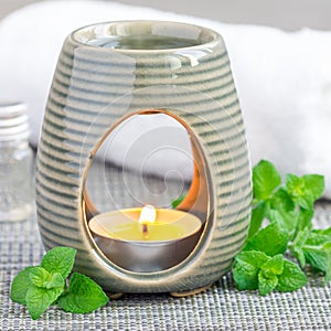 Peppermint essential oil in aroma lamp, square format