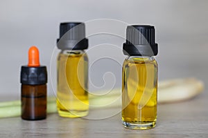 Peppermint essential oil in glass bottles on wooder background