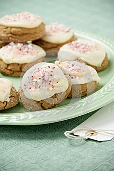 Peppermint frosted holiday cookies on a green plate