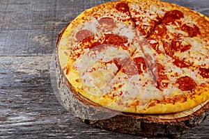 Pepperoni Pizza - Fresh homemade pizza with pepperoni, cheese and tomato sauce on rustic