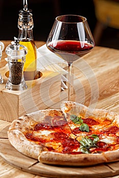 Pepperoni pizza and a glass of wine