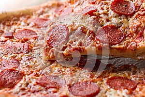 Pepperoni pizza with one slice cut off