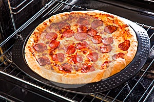 Pepperoni pizza in the oven. photo