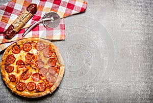 Pepperoni pizza with salami and cheese. On stone table.