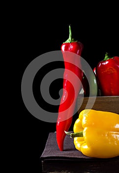 Peppers of different sorts in the wooden box