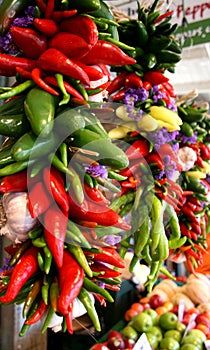 Peppers, Garlic, and Flowers Hanging in Market