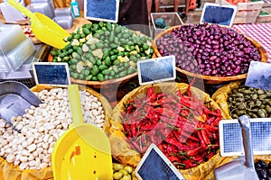 Peppers, olives and French beans in a market