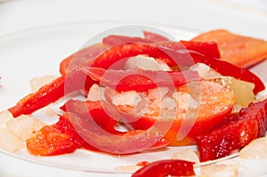Peppers, tomatoes and onions cut for cooking on a plate