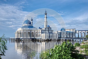 Outdoor scene of the famous architectural floating Tuminah Mosque photographs taken during different time of the day photo