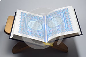 Perak, Malaysia - Oktober 25,2020 : Holy Quran Isolated on A Wooden Plate with White Background