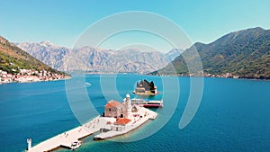 Perast, Bay of Kotor, Montenegro. Drone flying over the Our Lady of the Rocks. The island Saint George on the background