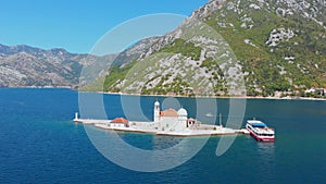 Perast, Bay of Kotor, Montenegro. Drone flying over the Our Lady of the Rocks. The island Saint George on the background