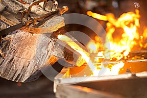 perator pouring molten metal in automatic casting line in foundry factory