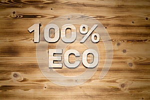 100 percent ECO words made of wooden block letters on wooden board
