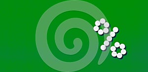 A percent sign of drugs on a green background top view with copy space.