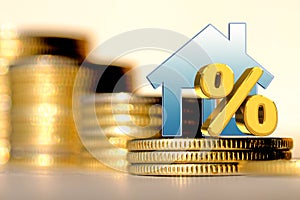 The percent symbol and real estate on a background of money .