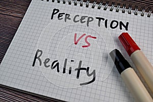 Perception or Reality write on a book isolated on the table photo