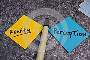 Perception or Reality write on a sticky note isolated on the table