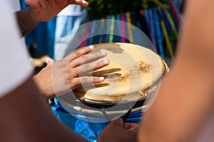 Percussionist hands playing atabaque