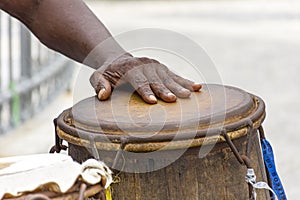 Percussionist playing a rudimentary atabaque during afro-brazilian capoeira fight photo