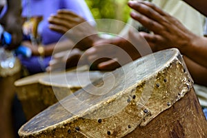 Percussionist playing a rudimentary atabaque photo