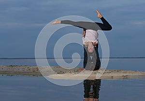 Perfect acroyoga. Beautiful young couple is doing yoga