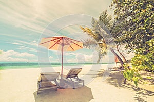 Beautiful beach. Chairs on the sandy beach near the sea. Summer holiday and vacation concept. Inspirational tropical scene. photo