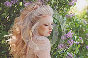 Perfect blonde model advertising long blowing hairstyle outdoors. Healthy wavy hair and beauty eyeshadow make up