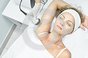 Perfect body radio treatment. Woman at spa procedure. Doctor hand and girl body. RF cosmetology lifting. Flabby hand