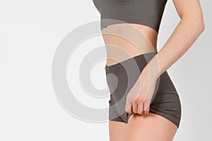 Perfect body shape close up on white background. Great figure of a tanned woman. Parts of a female body in underwear