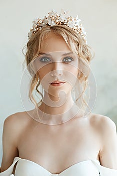 Perfect bride with jewels, a portrait of a girl in a long white dress. Beautiful hair and clean delicate skin. Wedding hairstyle