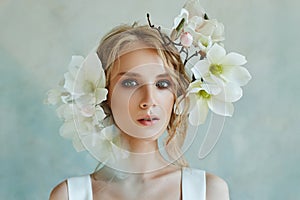 Perfect bride with jewels, a portrait of a girl in a long white dress. Beautiful hair and clean delicate skin. Wedding hairstyle