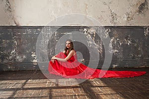 Perfect celebrity woman wearing red silky dress in vintage interior