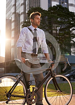 The perfect city transportation. a businessman commuting to work with his bicycle.