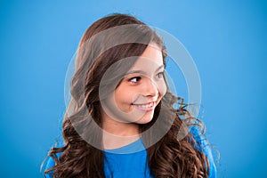 Perfect curling hair. Kid girl long healthy shiny hair. Teaching healthy hair care habits. Kid happy cute face with
