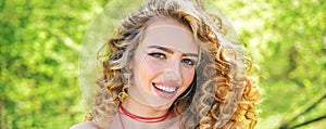 Perfect curly hair. Blonde curly long hair. Perfect woman smiling on spring sunny background. Beauty and perfect health